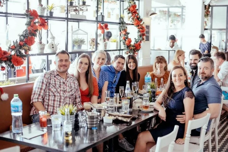 A table of friends and family celebrating over brunch at Maison Mathis