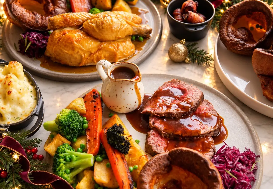 Roast beef with gravy, roast potatoes, Yorkshire puddings and winter vegetables on a festive table